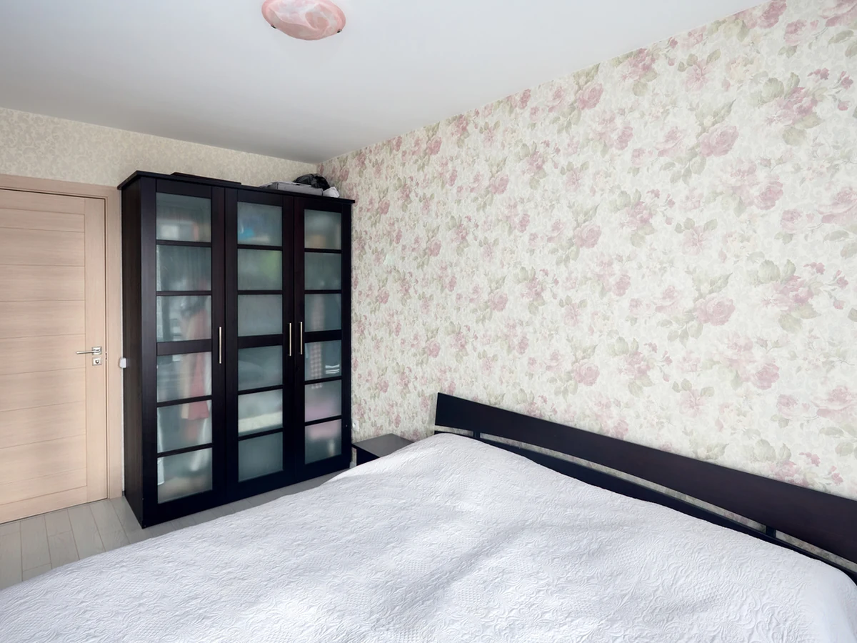 Small bedroom with floral wallpaper in Chesterfield by Chesterfield Decorators