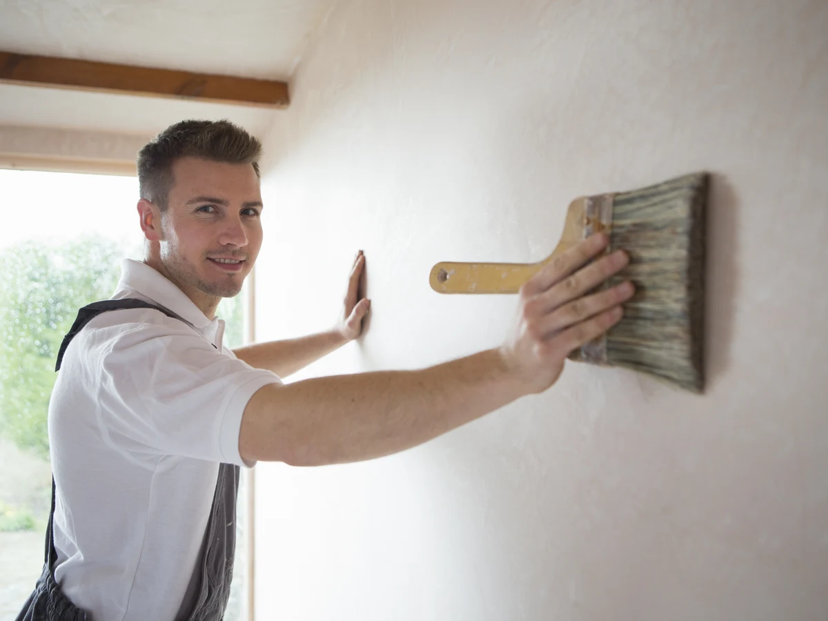 Decorator painting a large wall in a Brampton property by Chesterfield Decorators