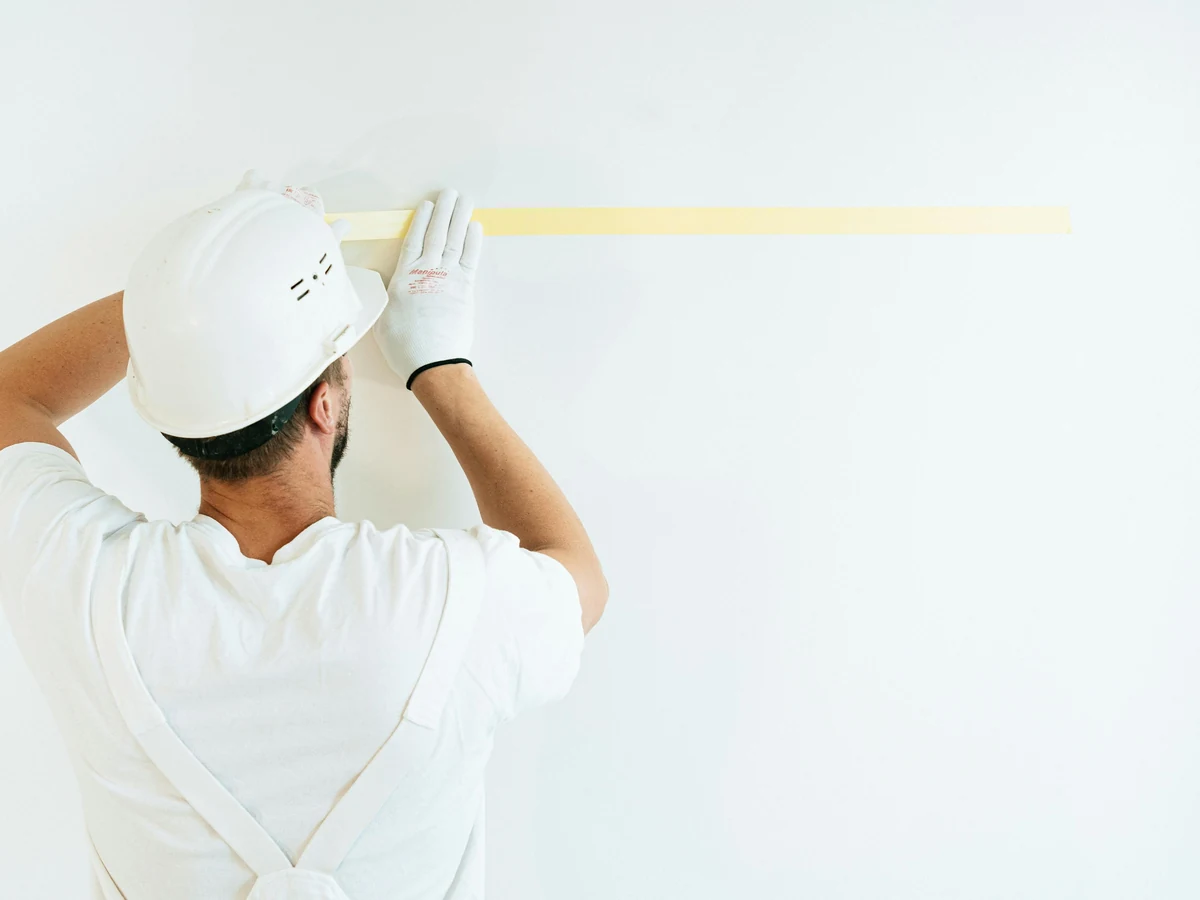 painting-decorating-painter-applying-masking-chesterfield-decorators Painter applying masking tape in Walton Chesterfield by Chesterfield Decorators