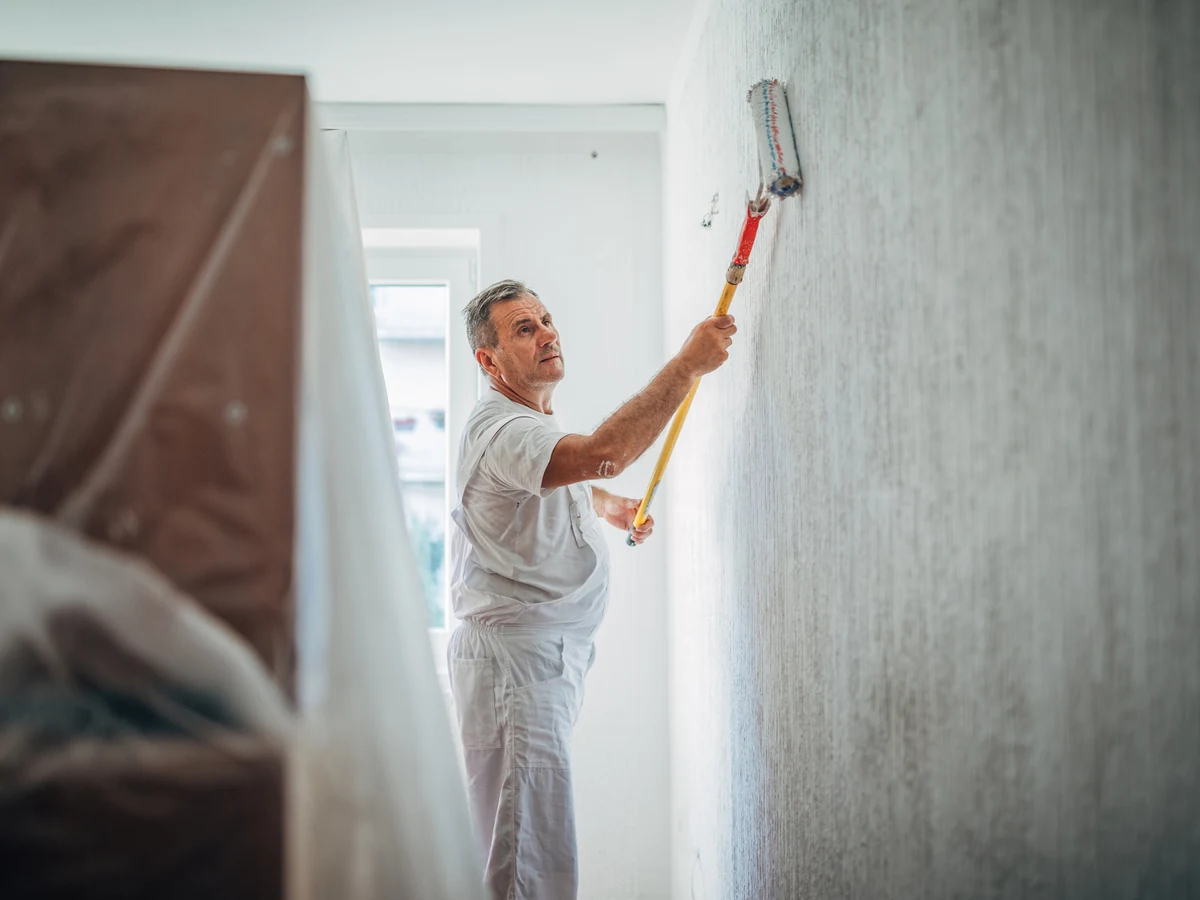 painting-decorating-painter-white-overalls-chesterfield-decorators Painter in white overalls decorating a Somercotes home by Chesterfield Decorators