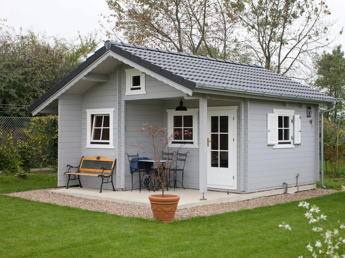 Grey painted log cabin summerhouse in Chesterfield garden